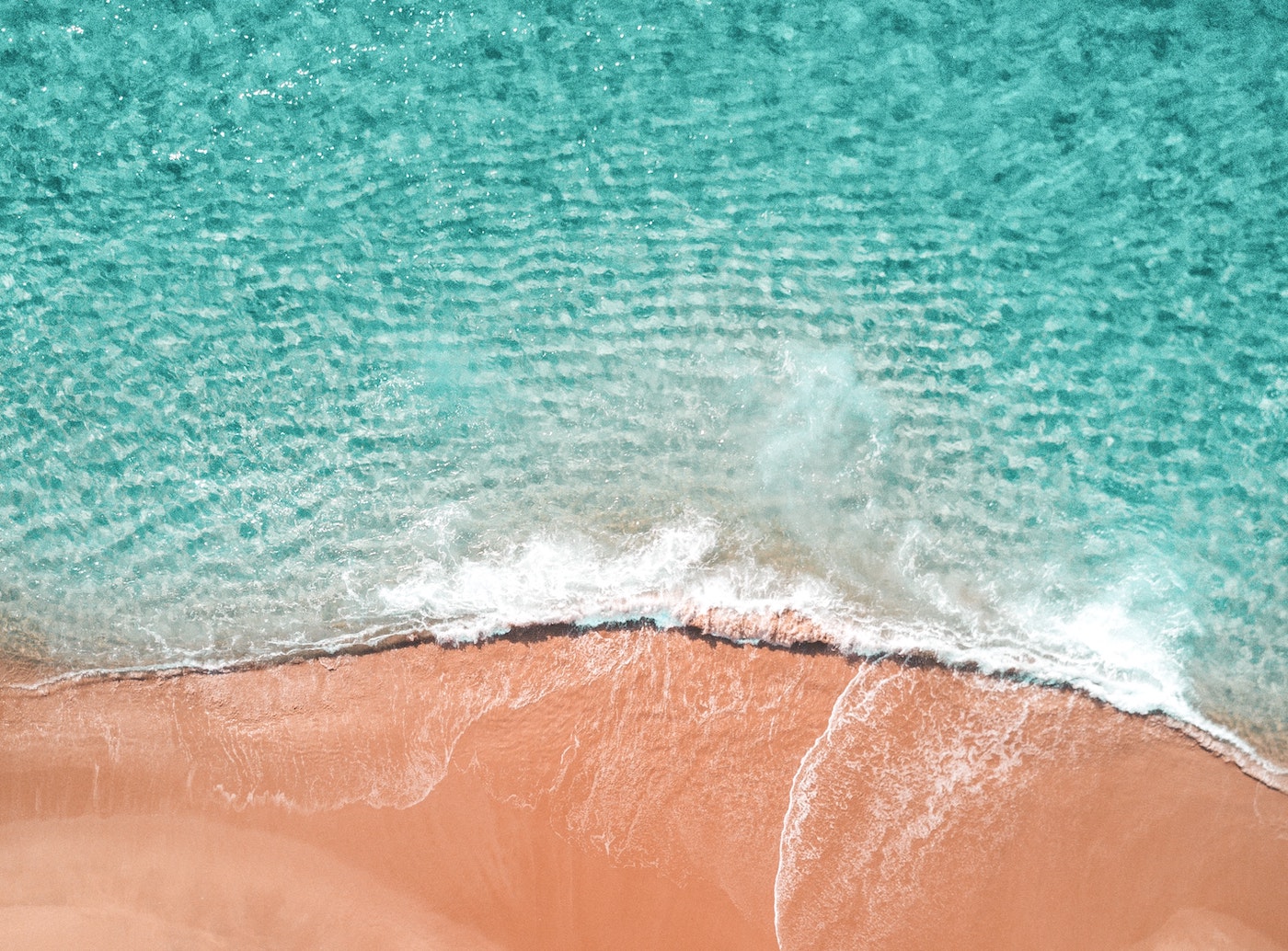 Aerial shot of ocean and sand