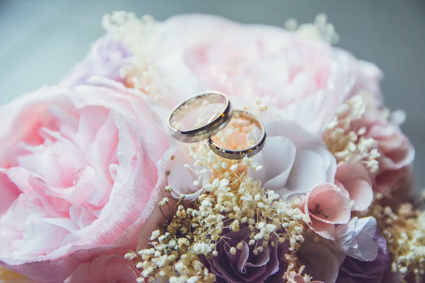 Two wedding rings on top of flowers